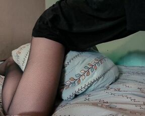 girl in fishnets is riding a pillow